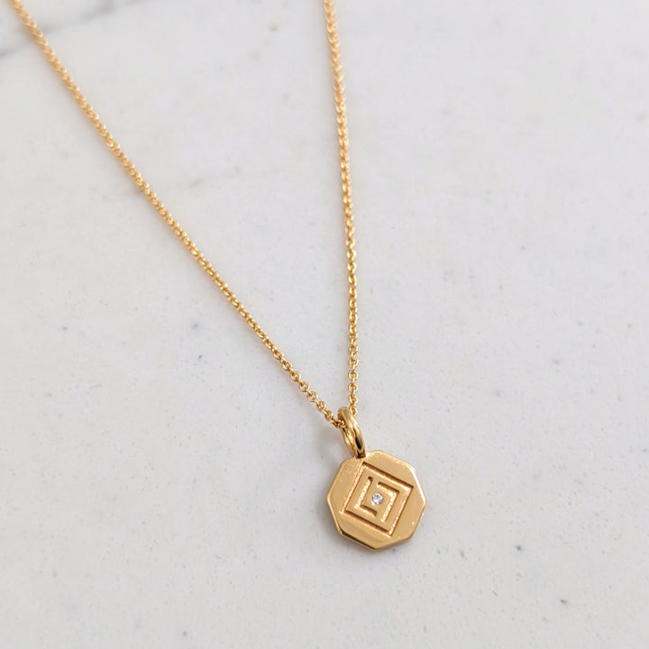 gold  chain with Lapis London logo disc charm