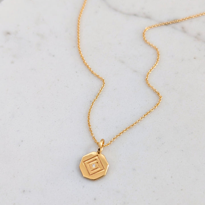 gold  chain with Lapis London logo disc charm