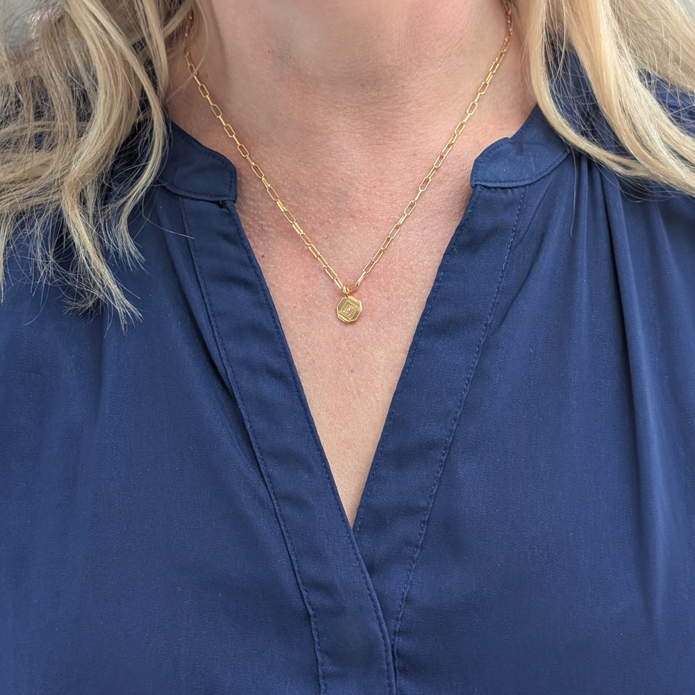 gold paperclip chain with Lapis London logo disc charm