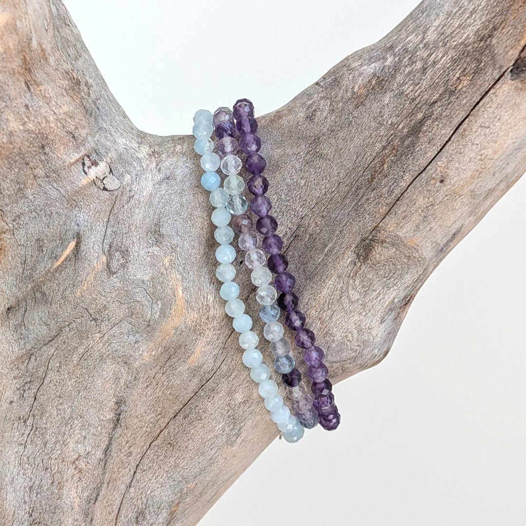 Aquarius gemstone bracelet set comprising amethyst, aquamarine and fluorite gemstone bracelets.