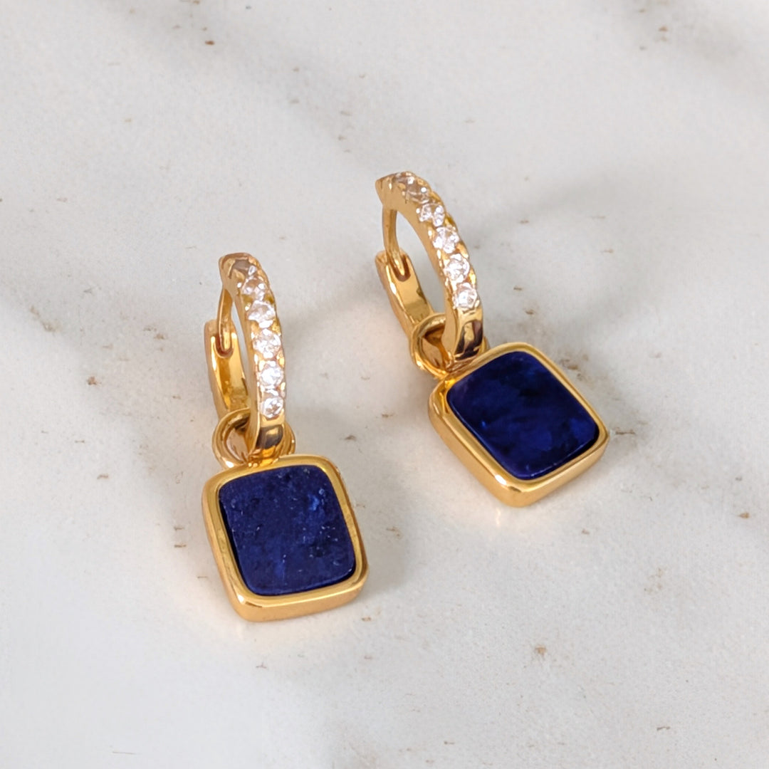 A pair of gold lapis lazuli square charms on eternity hoop earrings 