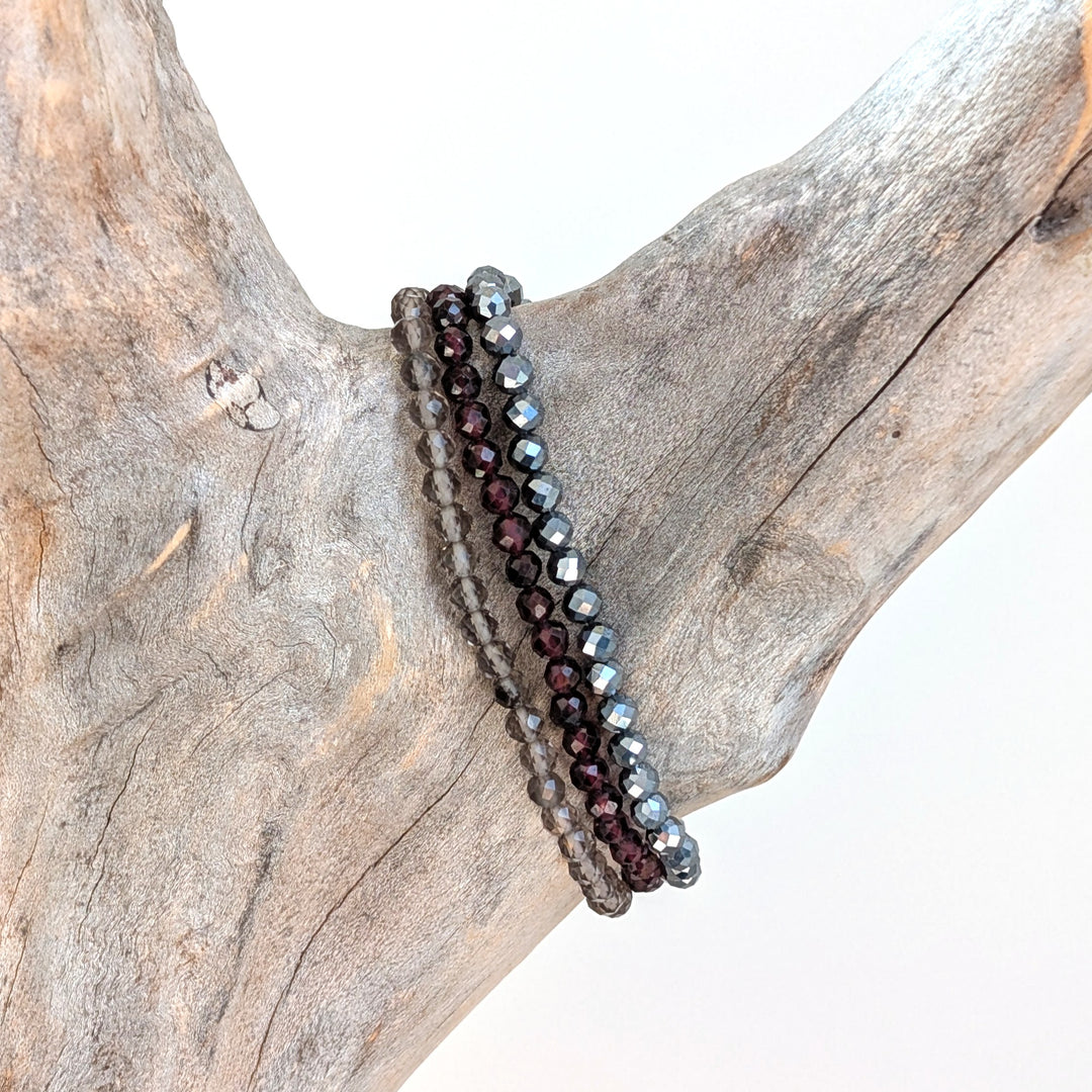 Capricorn gemstone bracelet set comprising hematite, garnet and smoky quartz gemstone bracelets. 