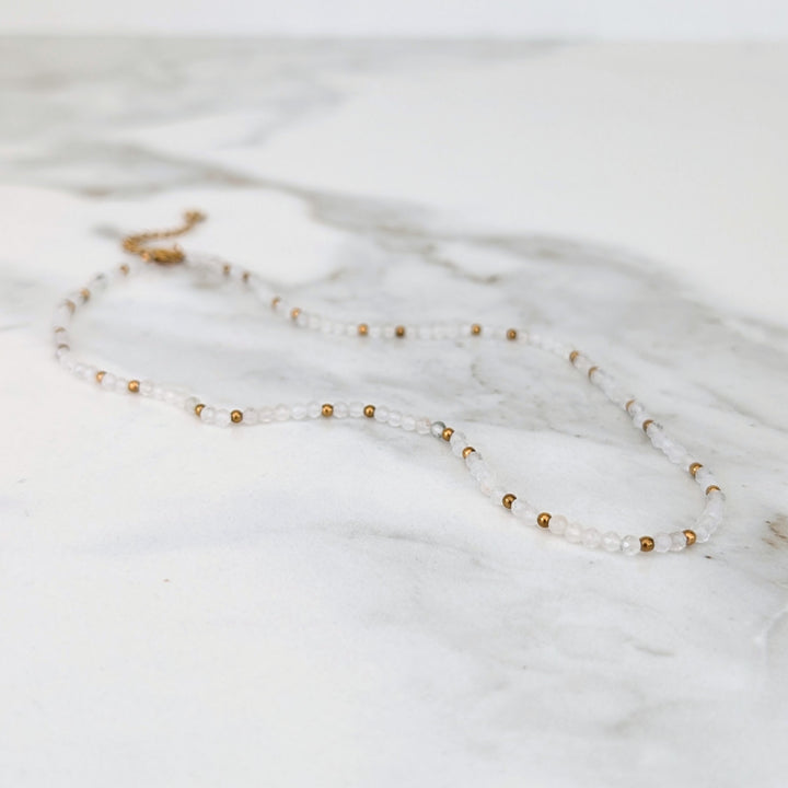 clear quartz gemstone and gold bead necklace 