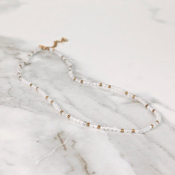 clear quartz gemstone and gold bead necklace 