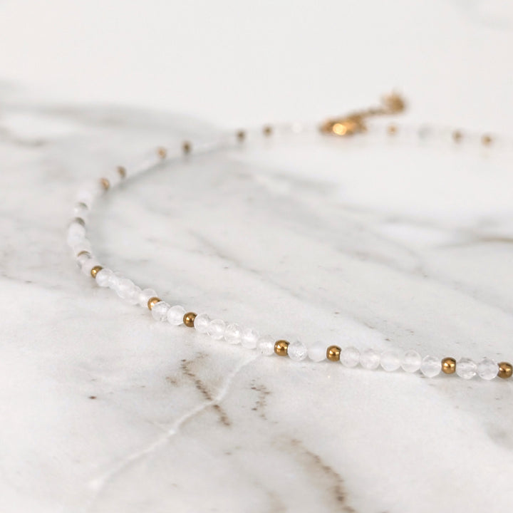 clear quartz gemstone and gold bead necklace 