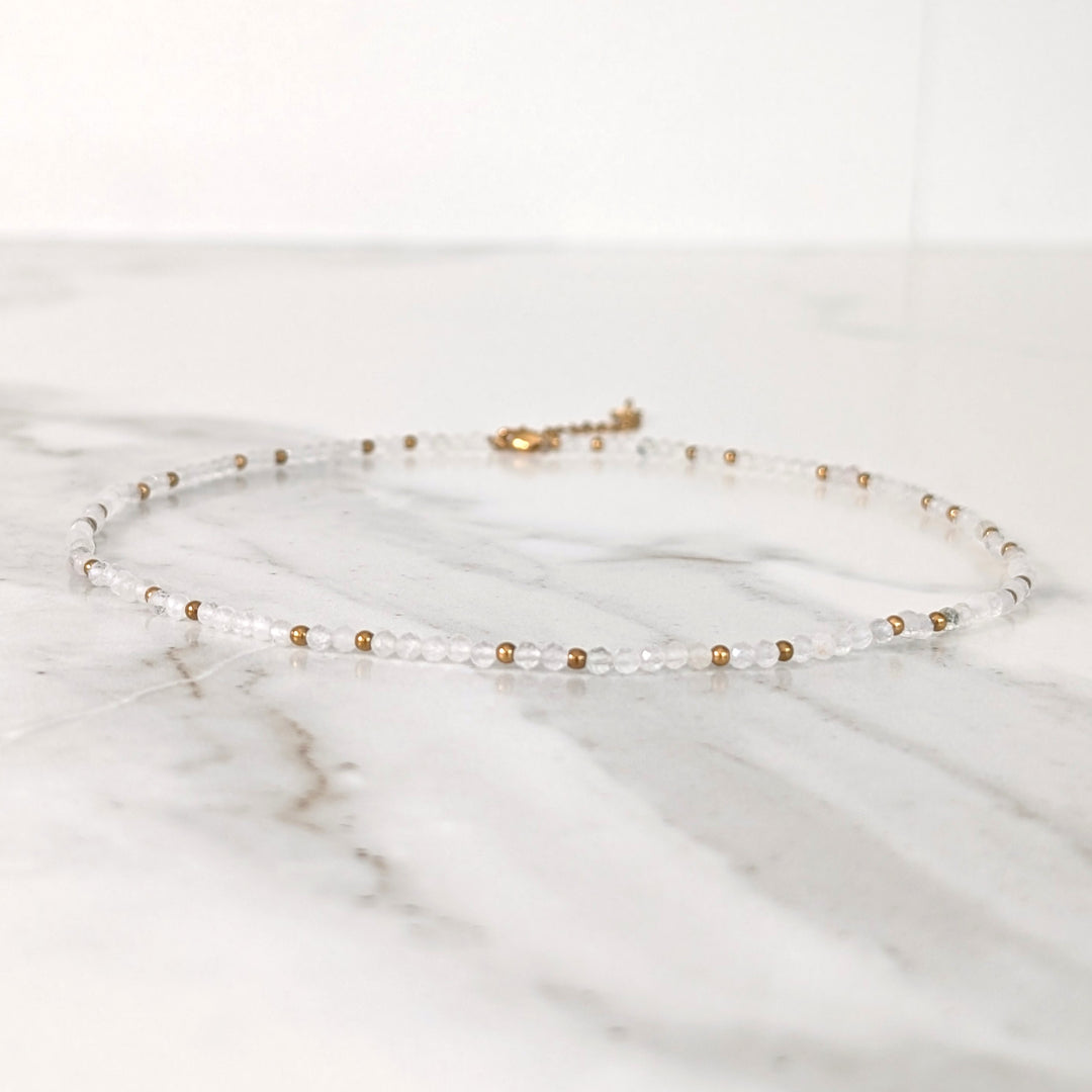 clear quartz gemstone and gold bead necklace 