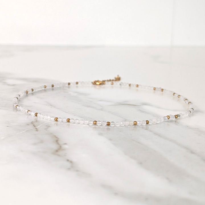 clear quartz gemstone and gold bead necklace 