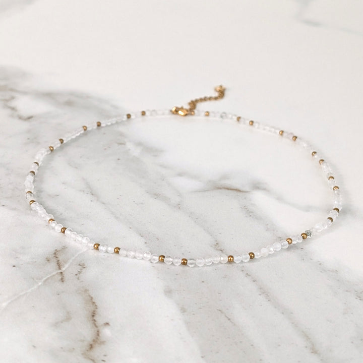 clear quartz gemstone and gold bead necklace 