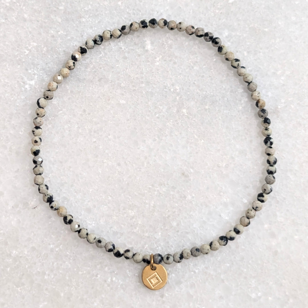skinny dalmatian jasper gemstone bracelet with 2mm faceted beads
