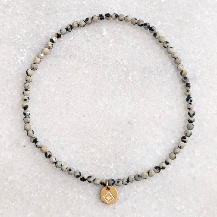 skinny dalmatian jasper gemstone bracelet with 2mm faceted beads