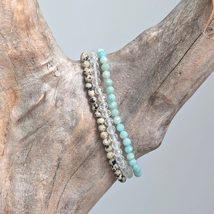 Health and wellbeing gemstone bracelet set comprising dalmatian jasper, clear quartz and amazonite bracelets.