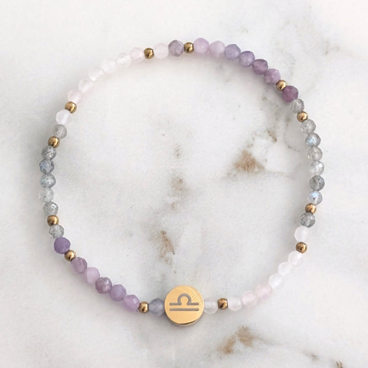 A beaded Libra zodiac stretch bracelet featuring labradorite, lepidolite and rose quartz faceted gemstone beads.