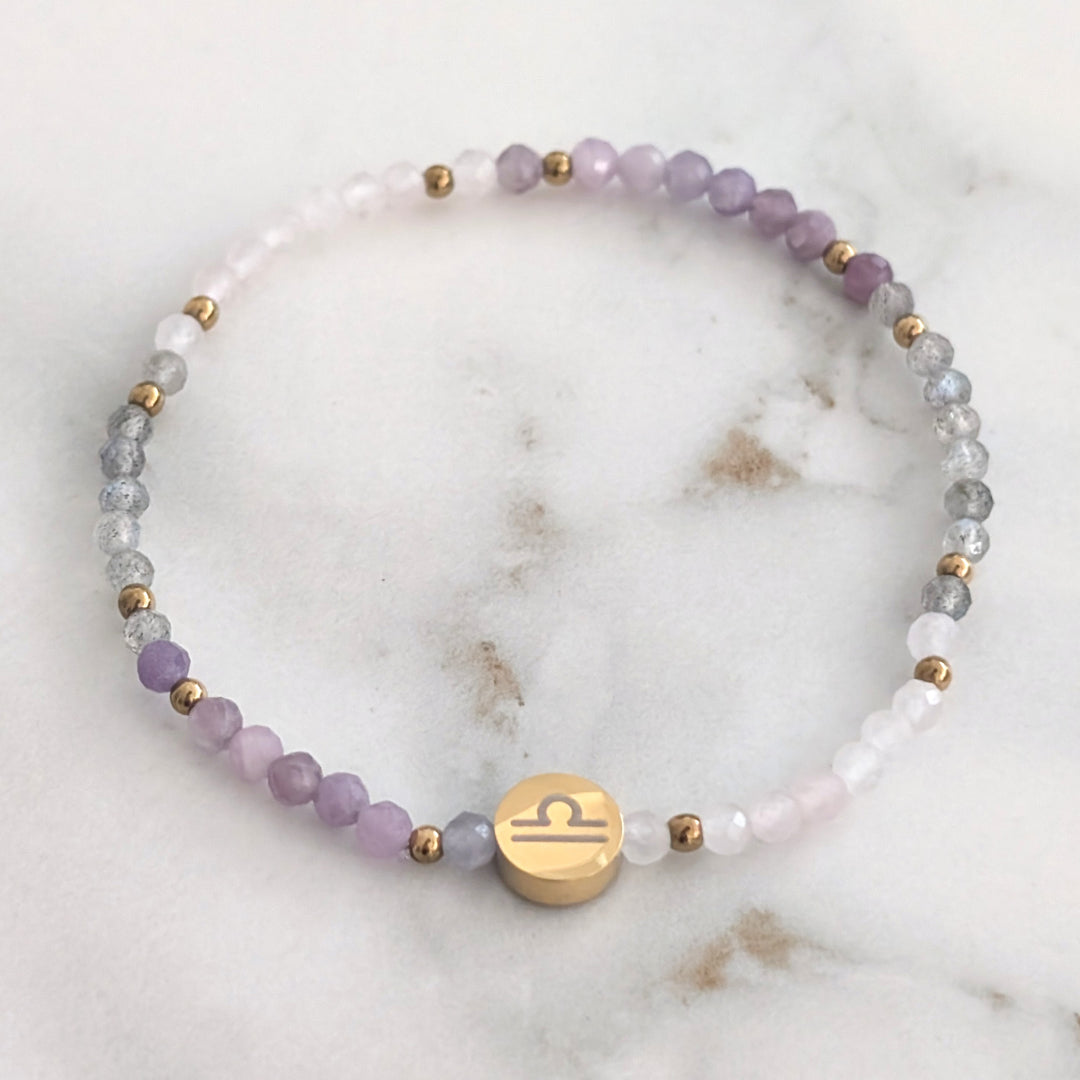 A beaded Libra zodiac stretch bracelet featuring labradorite, lepidolite and rose quartz faceted gemstone beads.