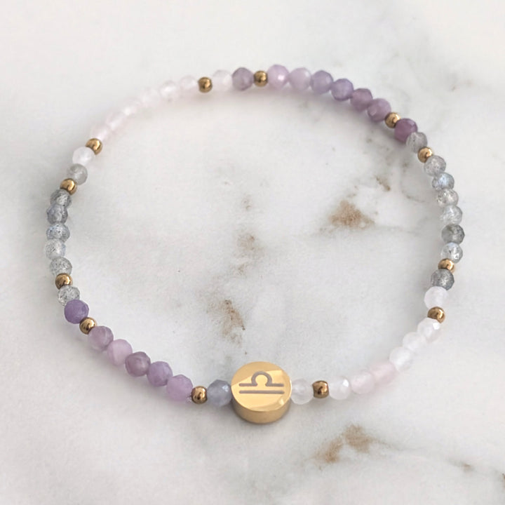 A beaded Libra zodiac stretch bracelet featuring labradorite, lepidolite and rose quartz faceted gemstone beads.