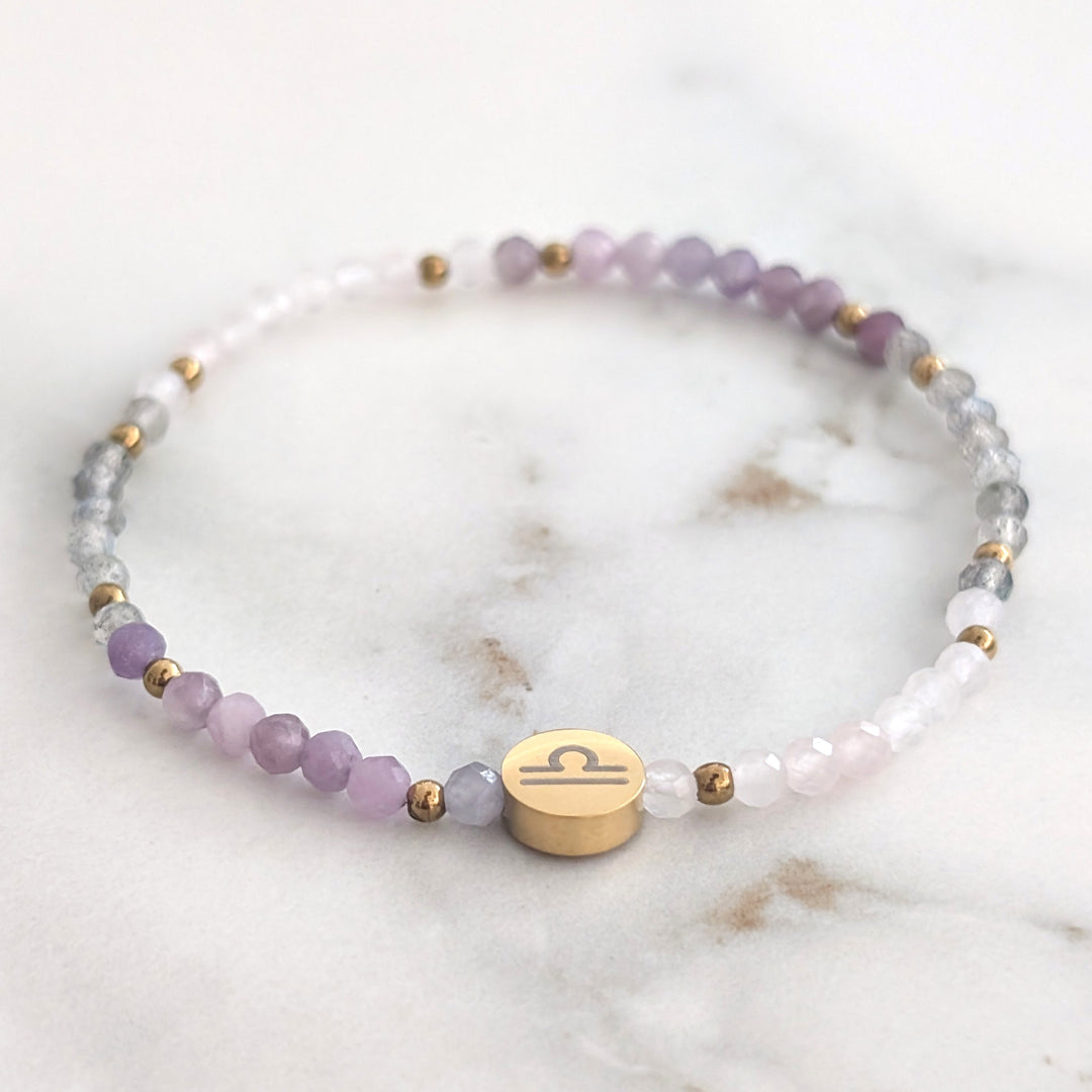 A beaded Libra zodiac stretch bracelet featuring labradorite, lepidolite and rose quartz faceted gemstone beads.