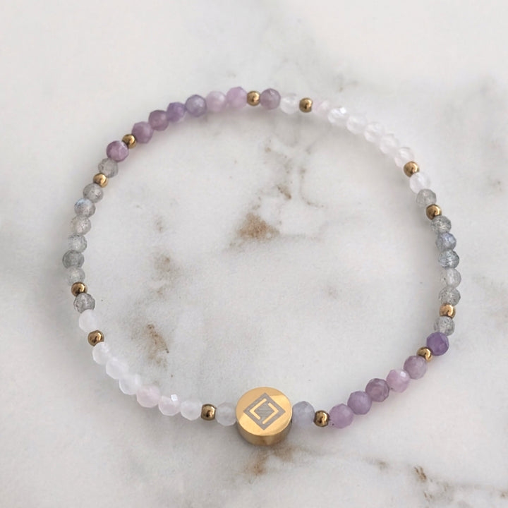 A beaded Libra zodiac stretch bracelet featuring labradorite, lepidolite and rose quartz faceted gemstone beads.