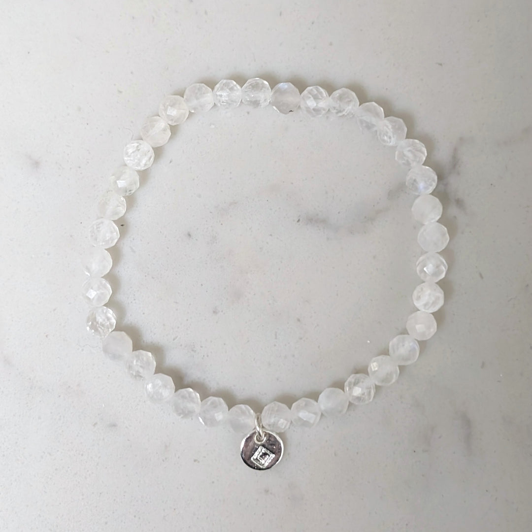 Beaded children's moonstone June birthstone bracelet with a silver disc charm