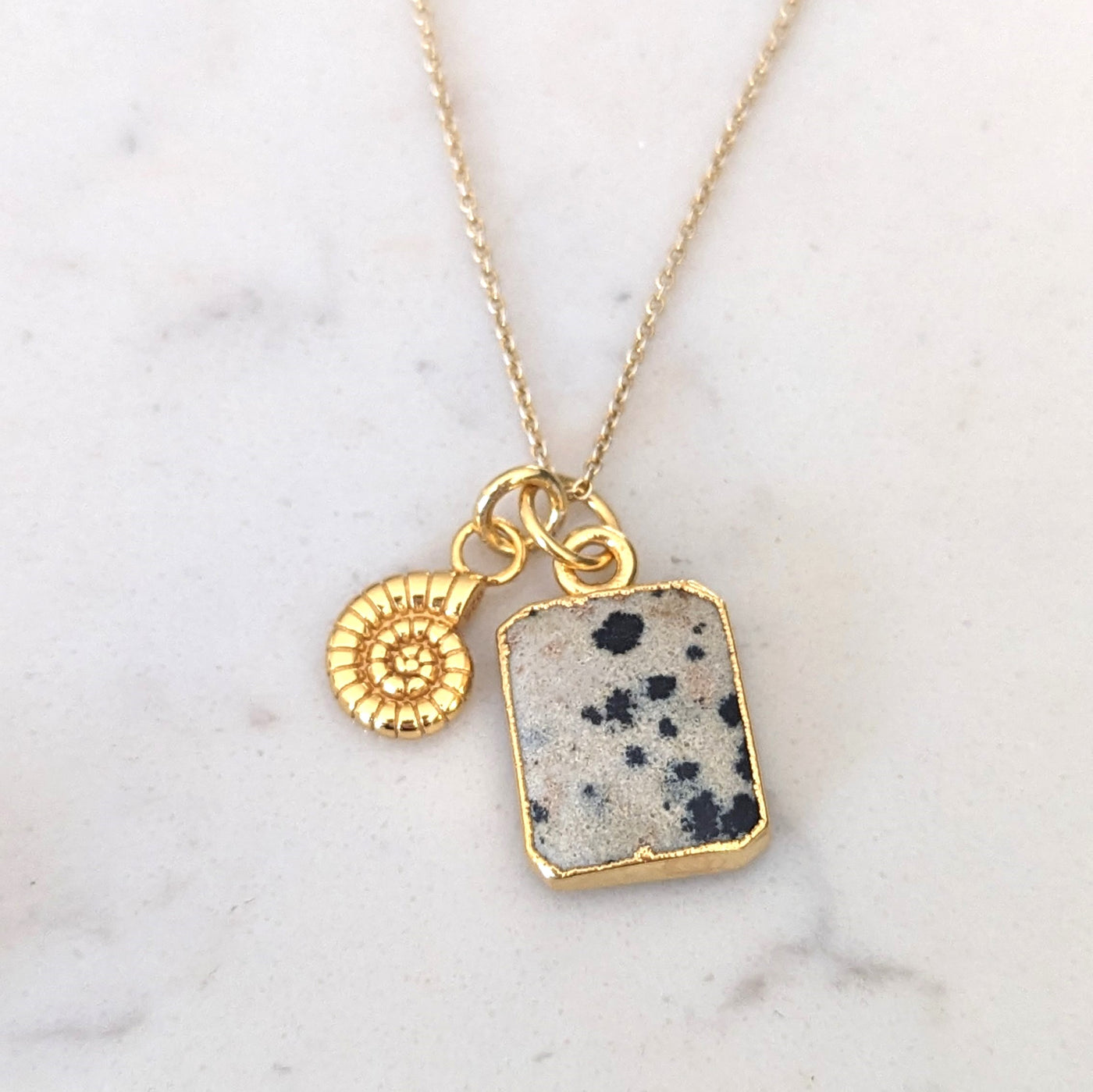 Gold dalmatian jasper and ammonite charm necklace