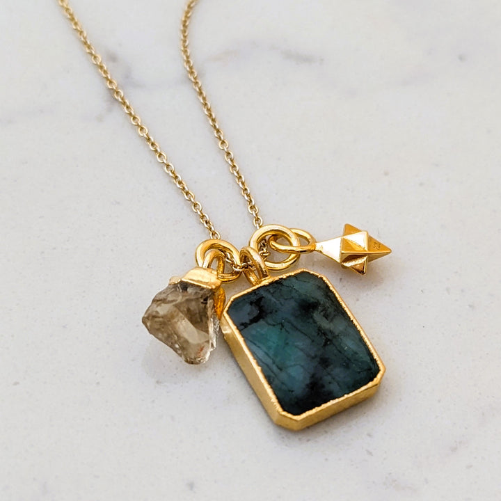 Emerald citrine and charm gold necklace