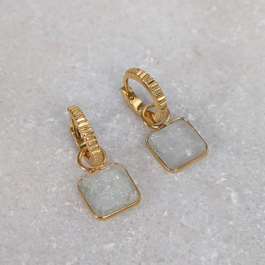 Gold hoop earrings with square blue topaz gemstones 