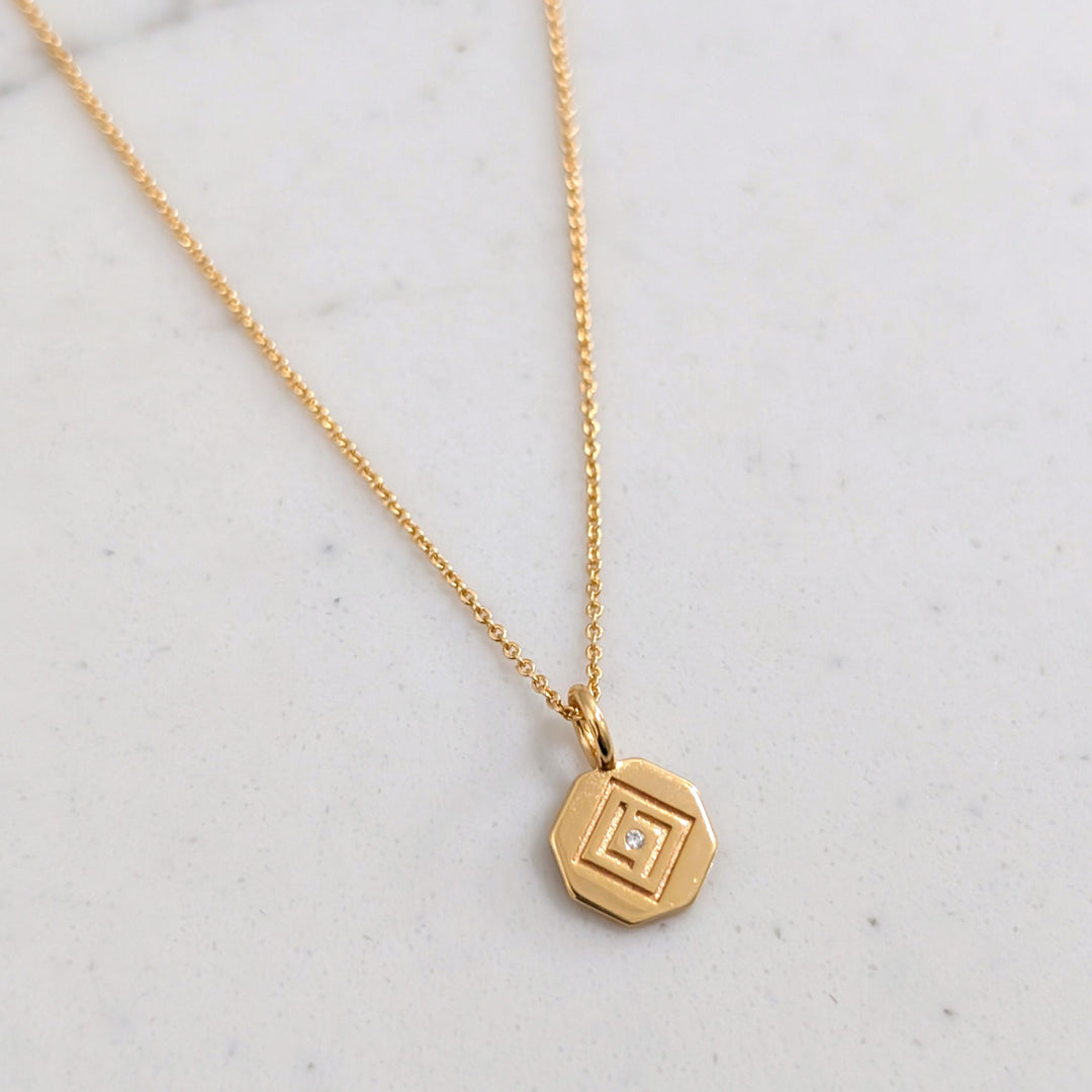gold  chain with Lapis London logo disc charm 