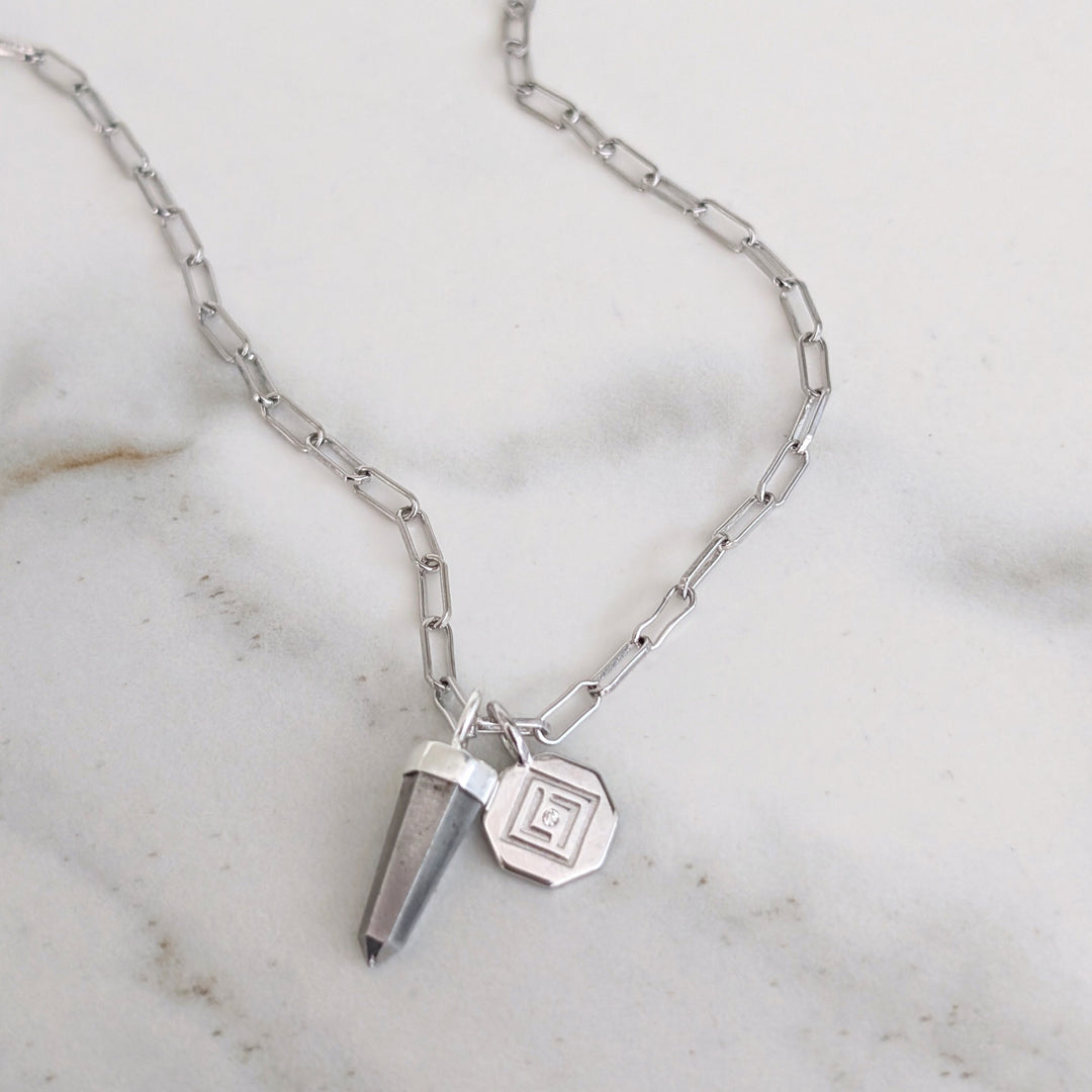 Silver necklace with a pyrite pendant and disc charm