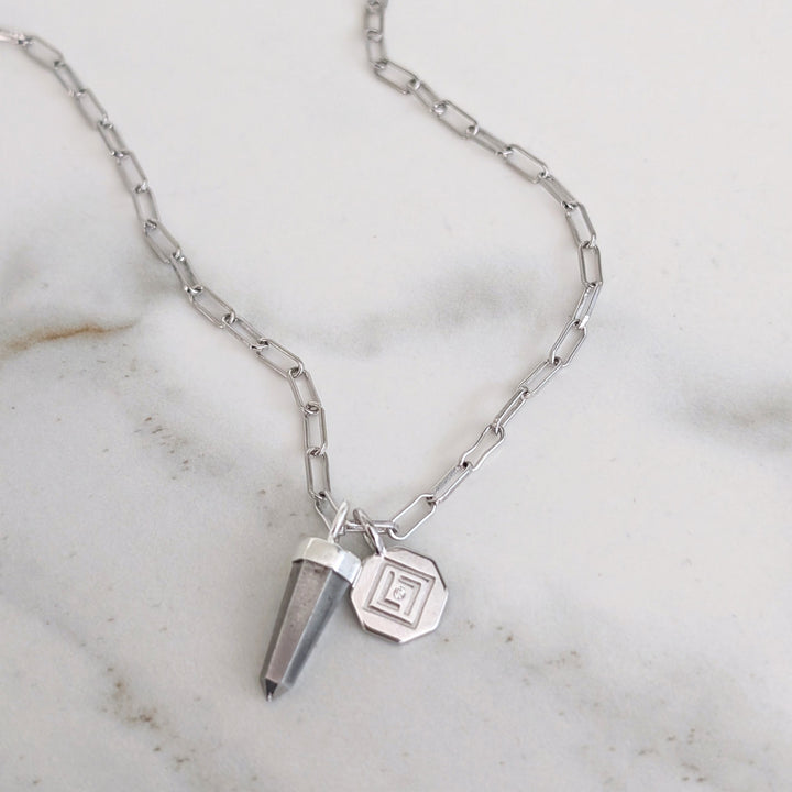 Silver necklace with a pyrite pendant and disc charm