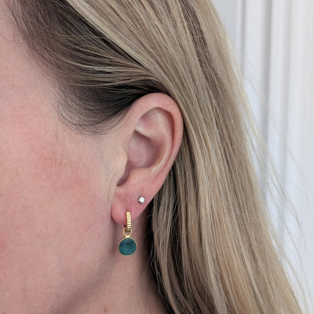 gold hoop earrings with emerald circular charms 