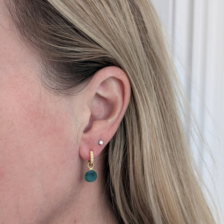 gold hoop earrings with emerald circular charms 