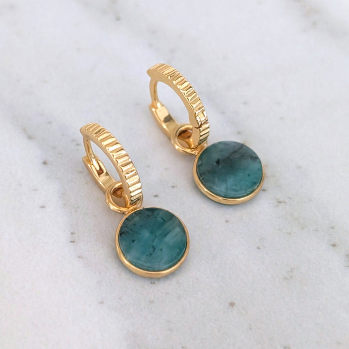 gold hoop earrings with emerald circular charms 