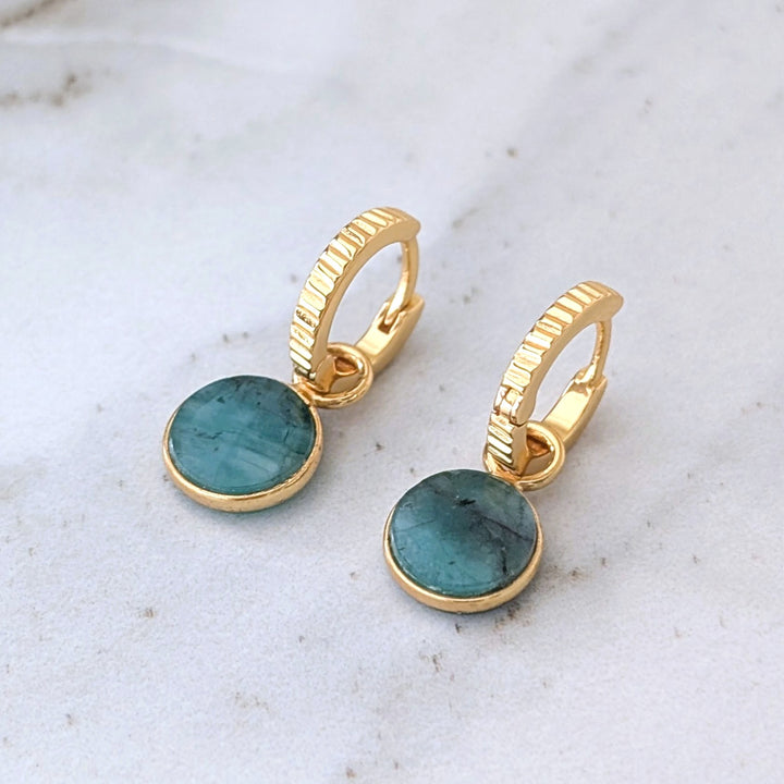 gold hoop earrings with emerald circular charms 