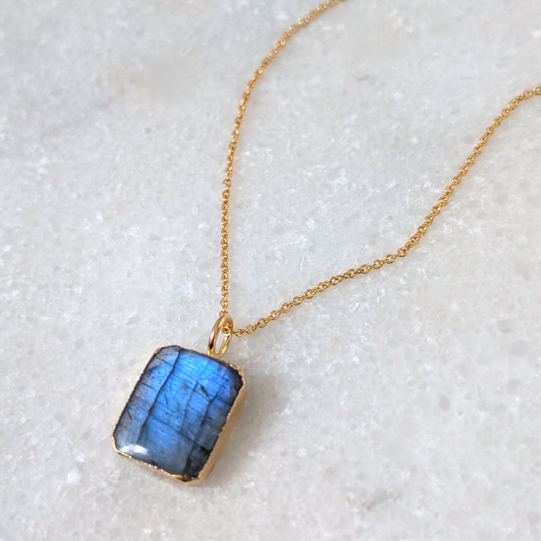 Gold necklace with a rectangular labradorite pendant
