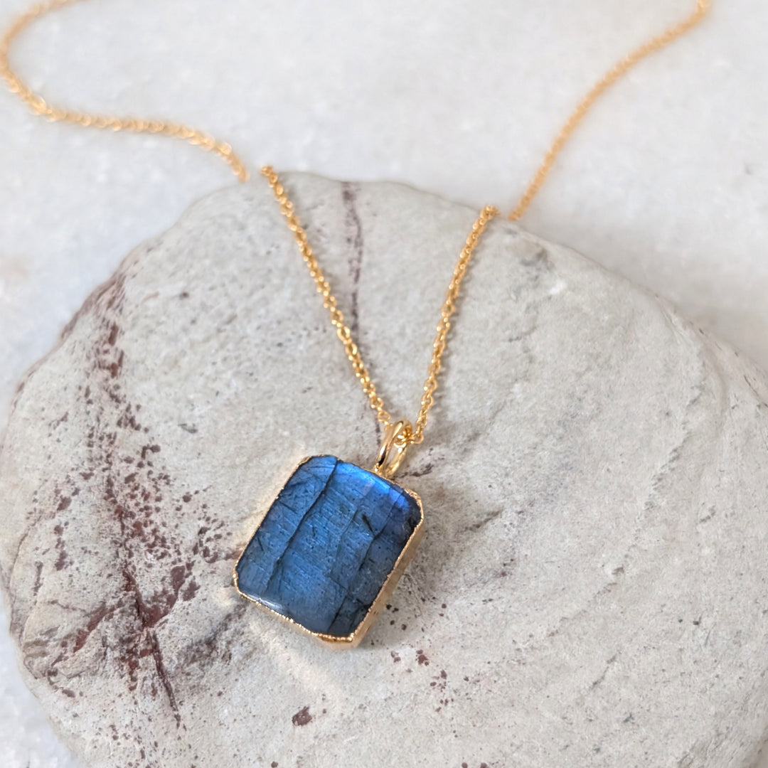 Gold necklace with a rectangular labradorite pendant