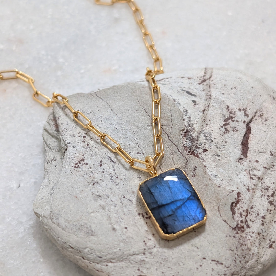 Gold necklace with a rectangular labradorite pendant