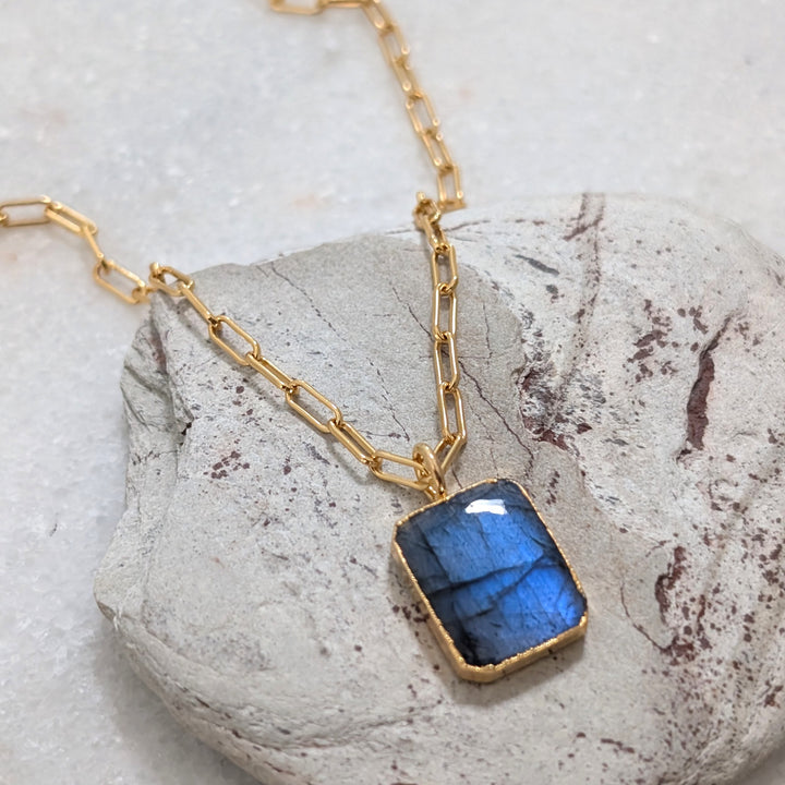 Gold necklace with a rectangular labradorite pendant