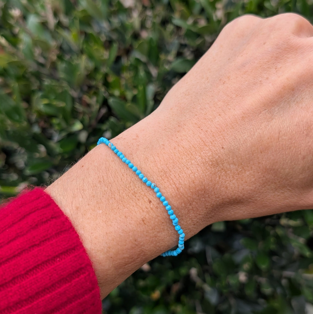 Blue Turquoise 2mm beaded bracelet with a silver charm