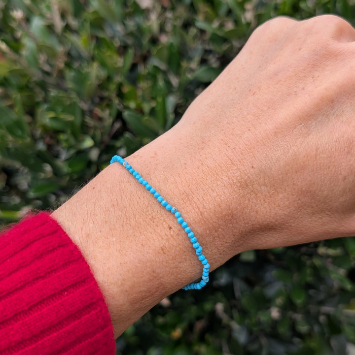 Blue Turquoise 2mm beaded bracelet with a silver charm