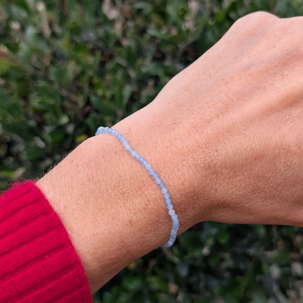 Light blue 2mm beaded aquamarine bracelet with a silver charm 