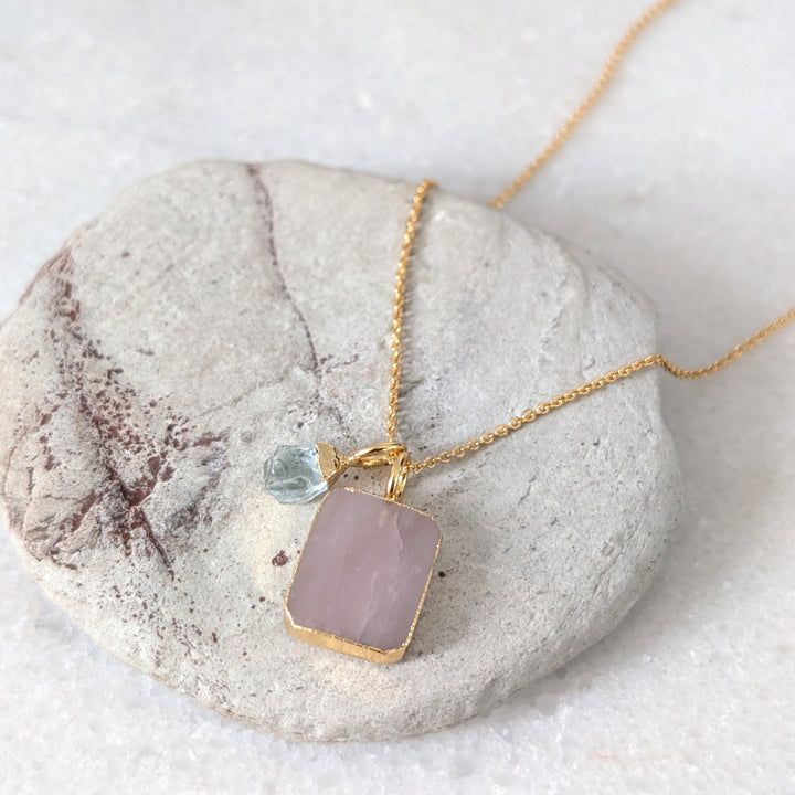 gold chain necklace with rose quartz rectangular pendant and aquamarine charm