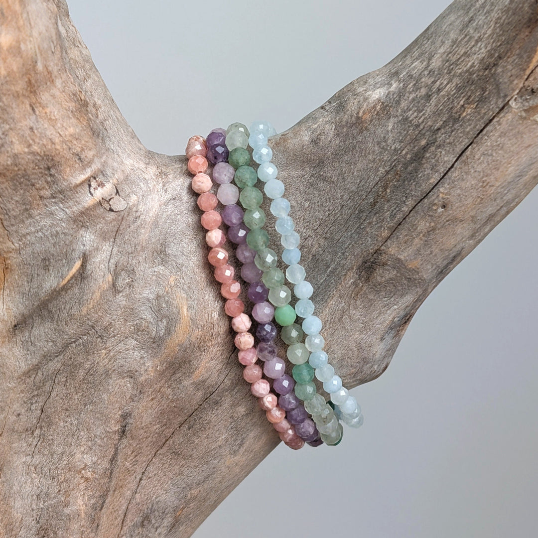 Good luck gemstone bracelet set comprising rhodochrosite, lepidolite, green aventurine and aquamarine bracelets.