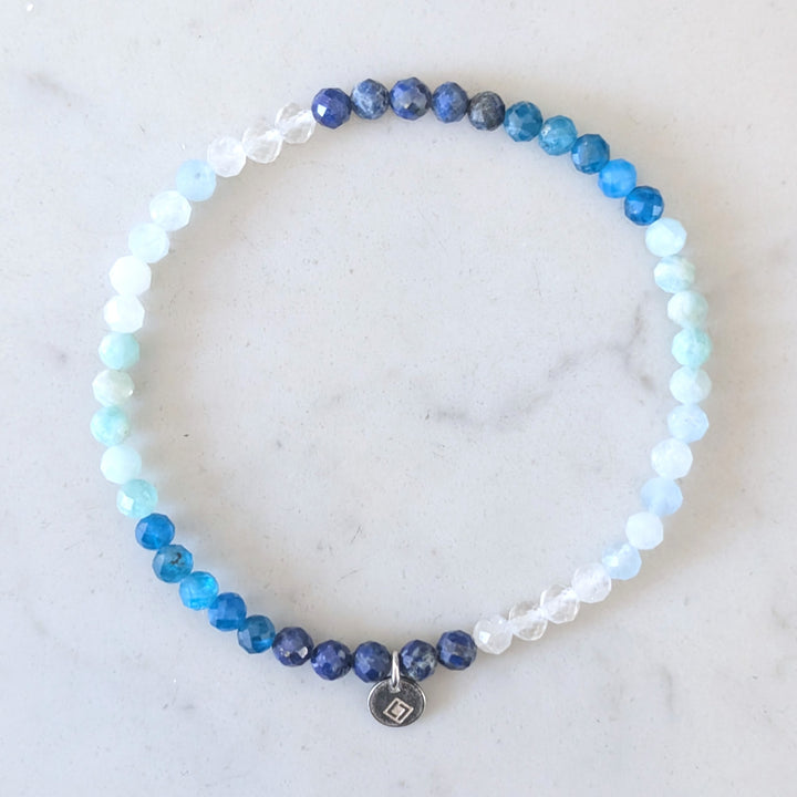 blue ombre gemstone bracelet comprising aquamarine, clear quartz, apaptite and lapis lazuli gemstone beads
