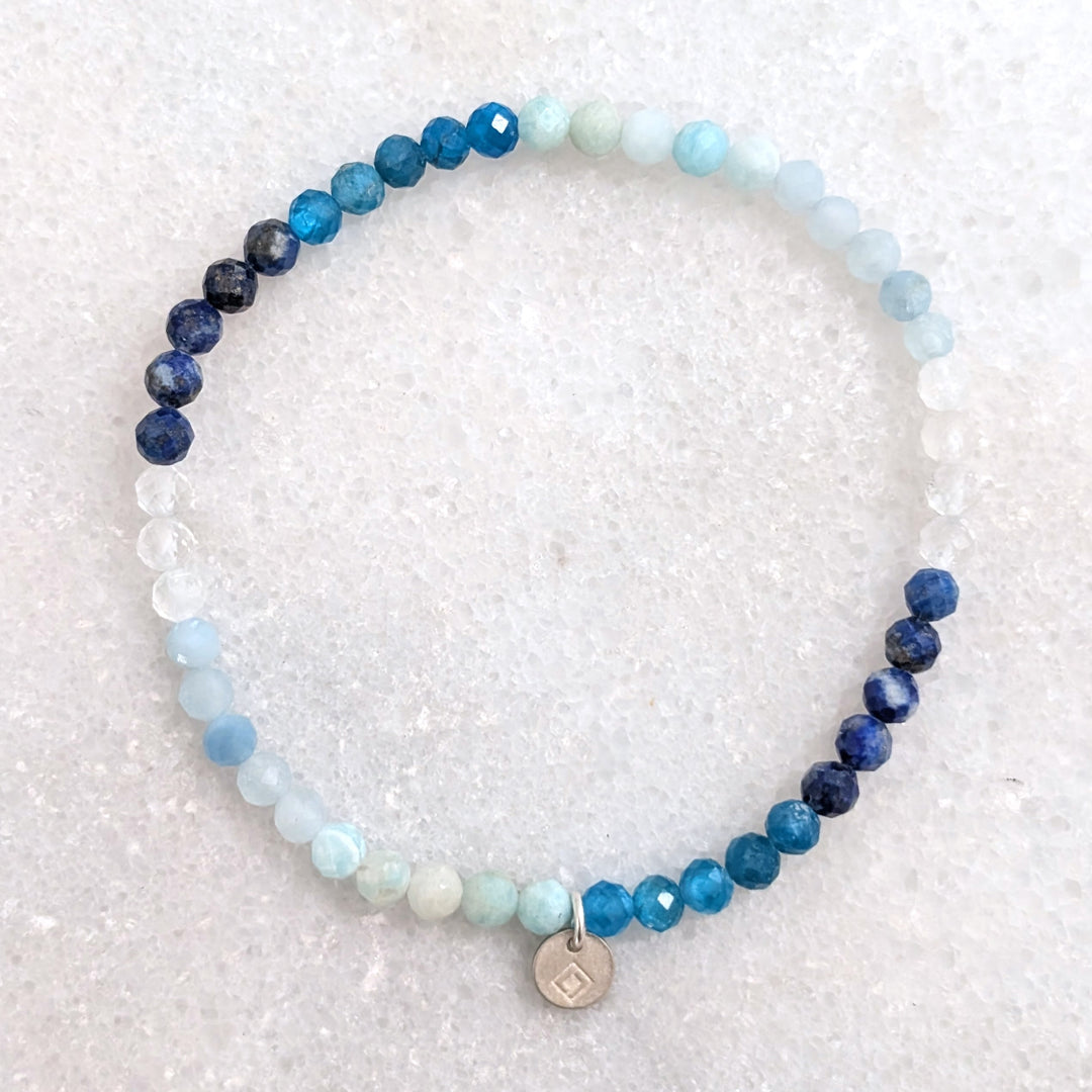 blue ombre gemstone bracelet comprising aquamarine, clear quartz, apaptite and lapis lazuli gemstone beads