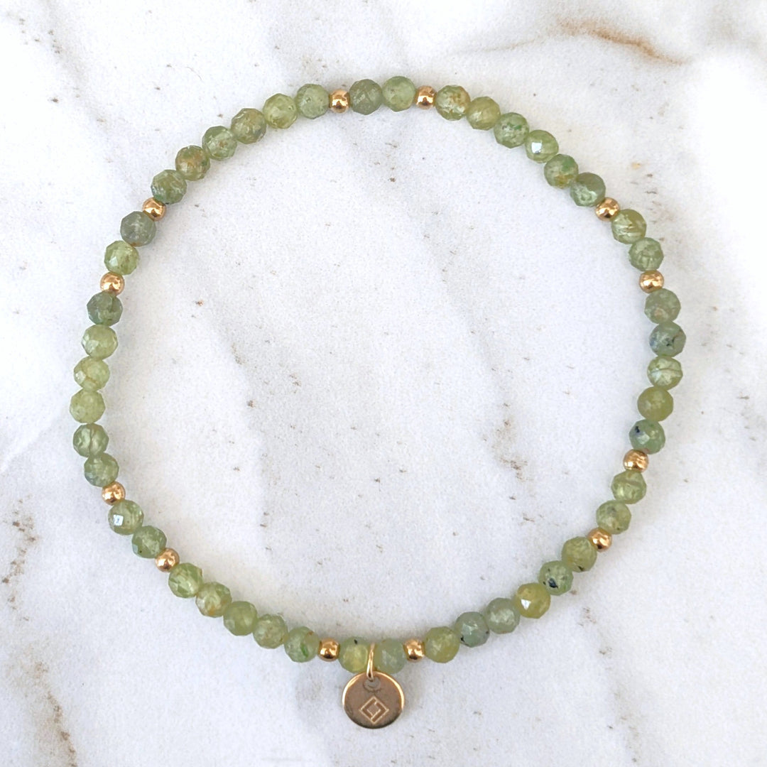 green peridot gemstone and gold bead bracelet 