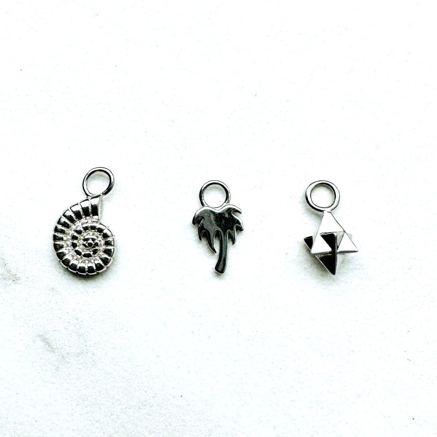 silver ammonite, palm tree and tetrahedron star necklace charms