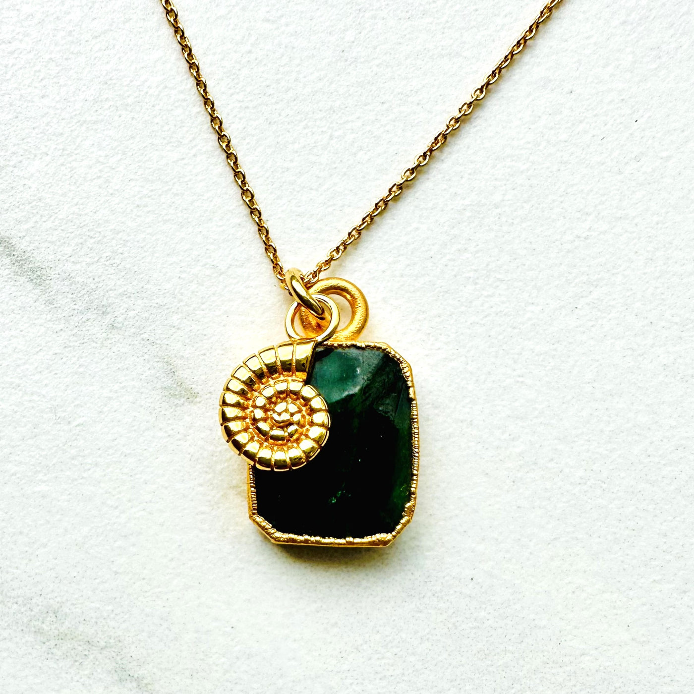 Gold plated emerald and ammonite charm pendant necklace