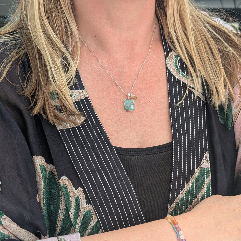 emerald rectangular pendant with citrine charm on a silver chain 