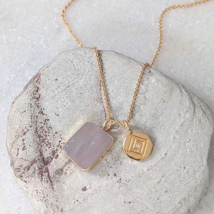 gold chain necklace with rose quartz rectangular pendant and gold disc charm