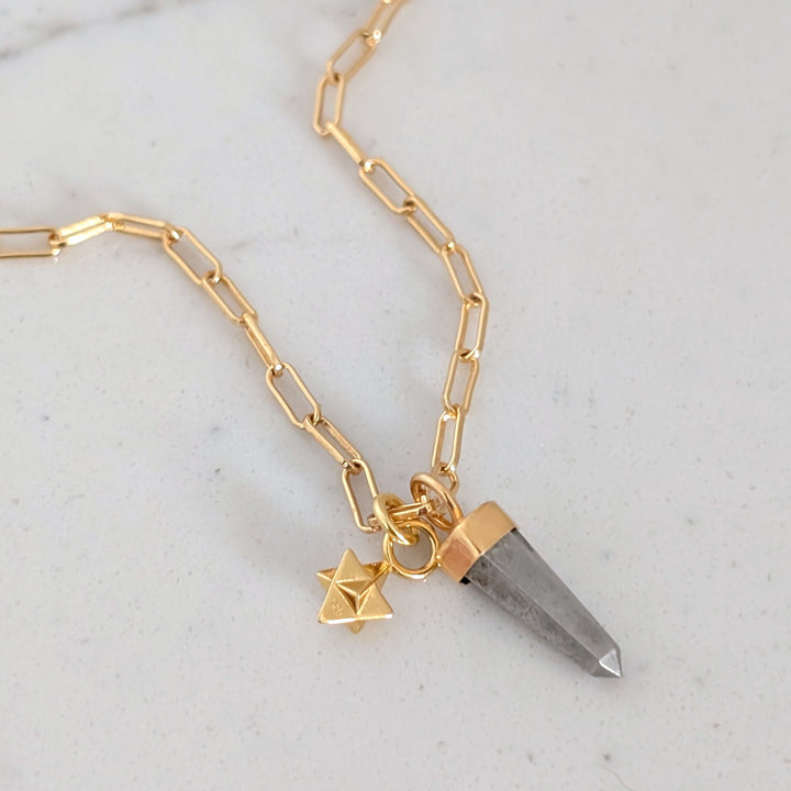 gold paperclip necklace with pyrite gemstone point pendant and tetrahedron star charm