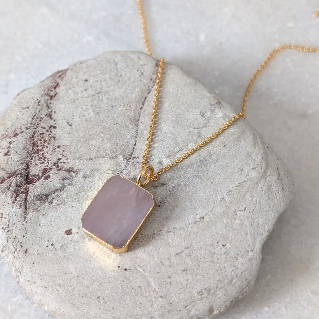 Gold necklace with a pink rose quartz rectangular pendant 