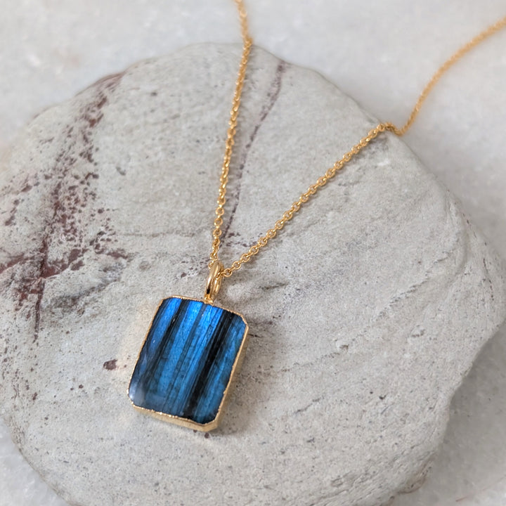 Gold necklace with a rectangular labradorite pendant